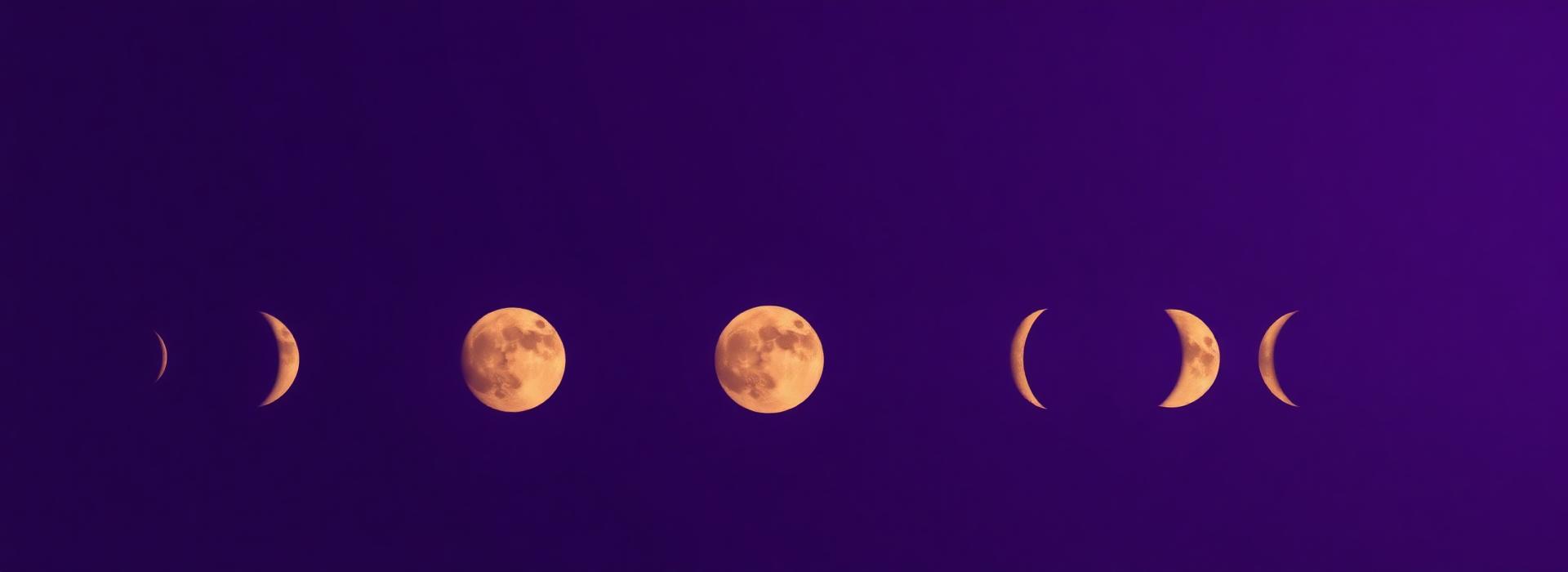 Phases of the moon rendered in gold on a midnight sky
